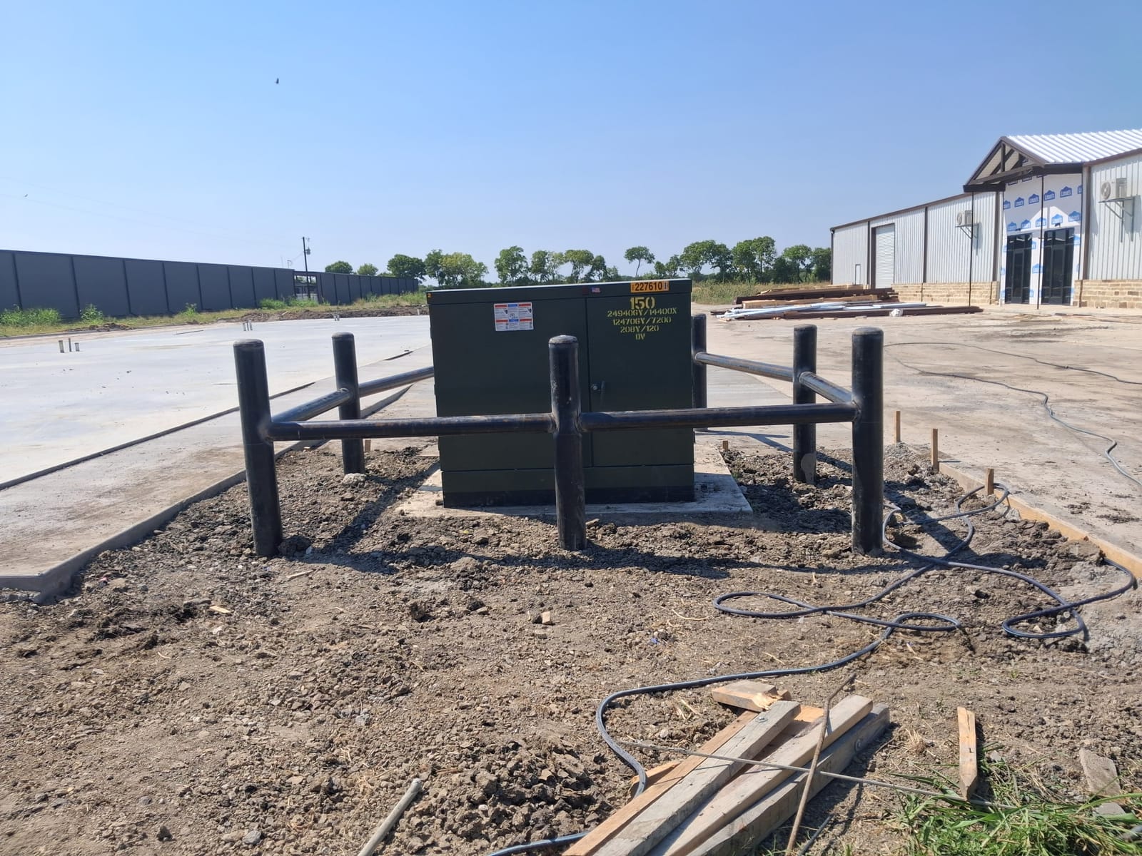 Steel bollards protecting an electrical transformer on a commercial site