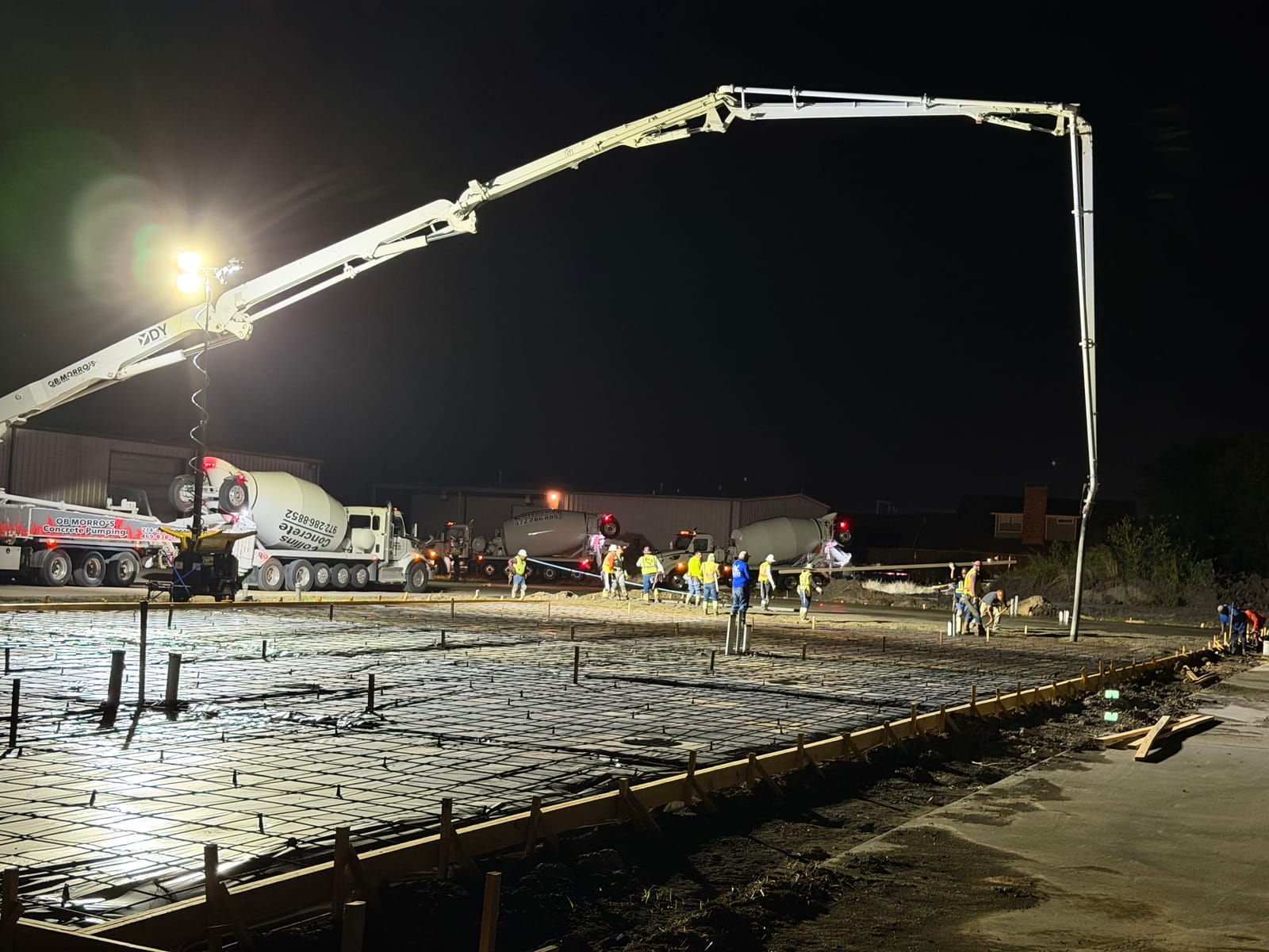 Big Dawgz Construction crew on a large commercial concrete pour at night