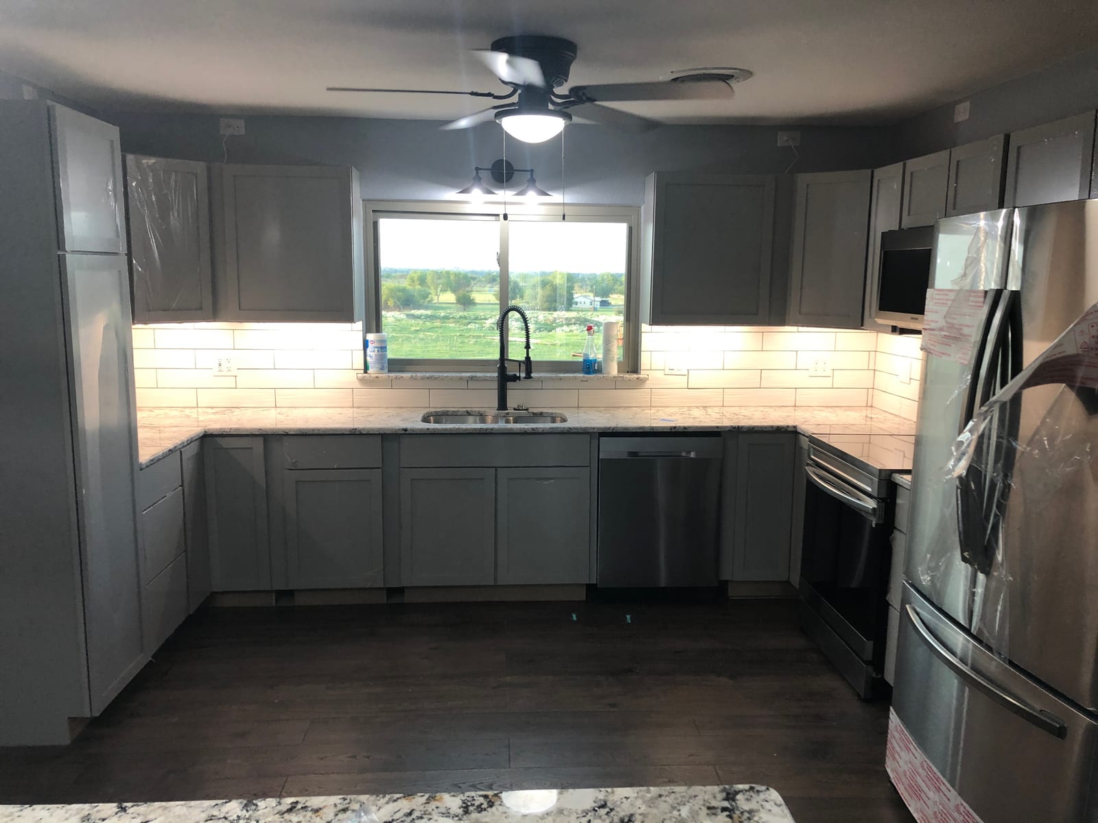 Finished kitchen remodel with new cabinets, granite counters, and stainless appliances